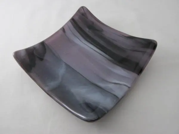 A square glass dish with black and gray stripes.