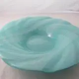 A blue bowl sitting on top of a table.