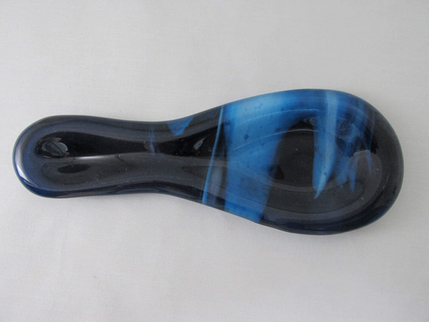 Blue and black glass massage tool.
