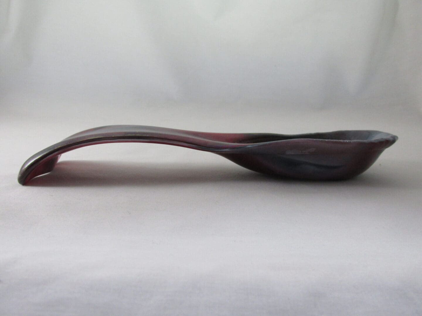 Curved, artistic black and red glass sculpture.