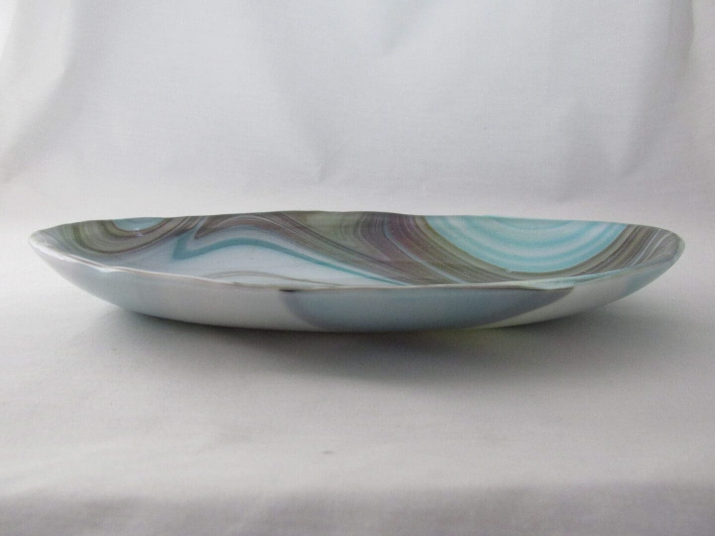 Marbled ceramic serving plate with blue swirls