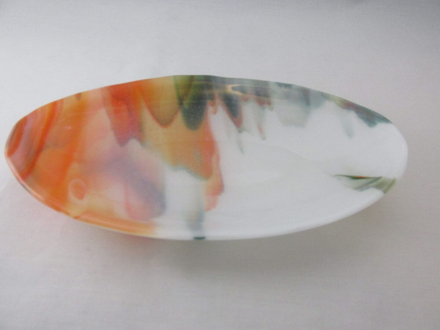 Oval ceramic platter with orange and green glaze