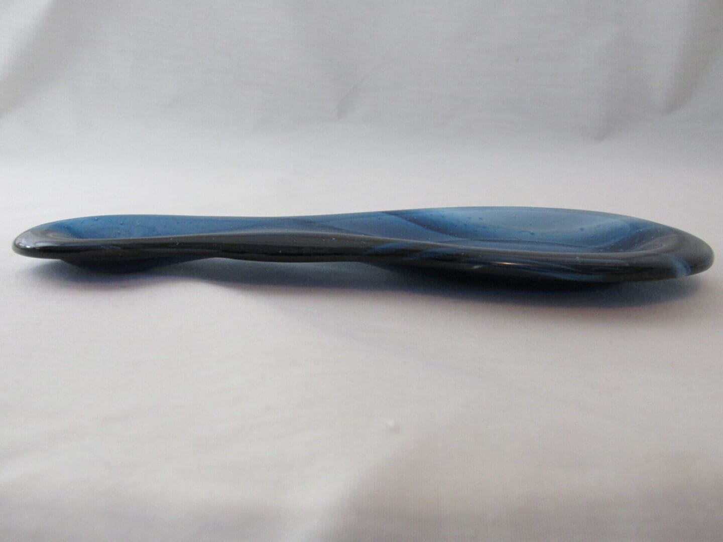 Sleek elongated blue glass spoon rest