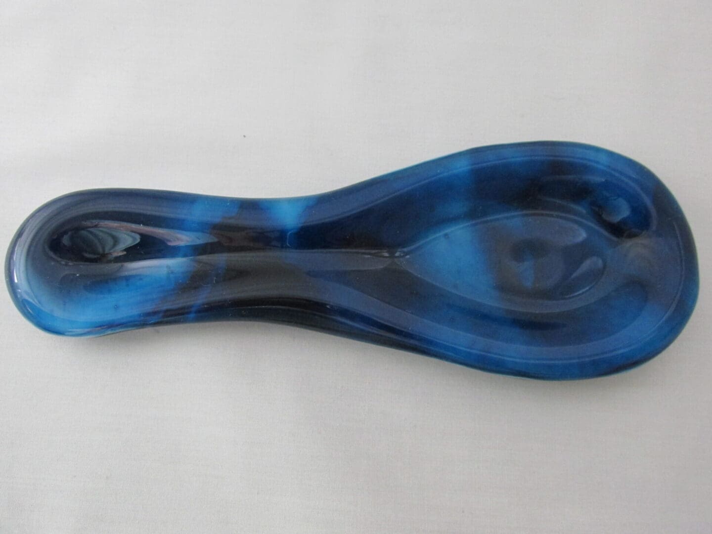 Elongated blue glass spoon rest