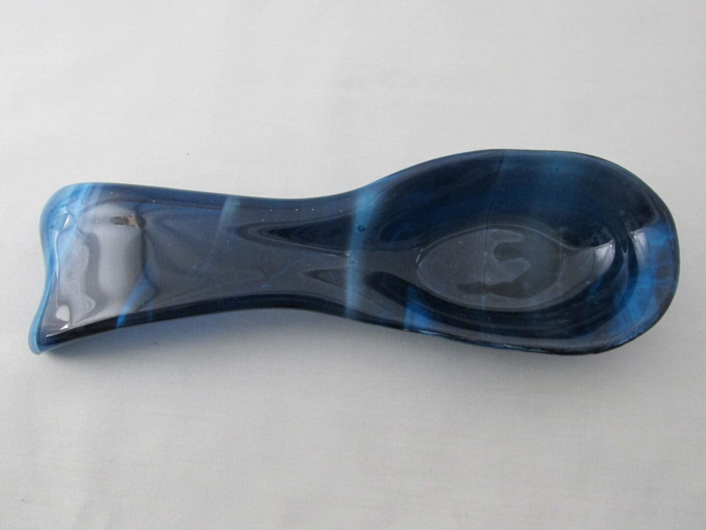 Elongated blue glass spoon-shaped dish