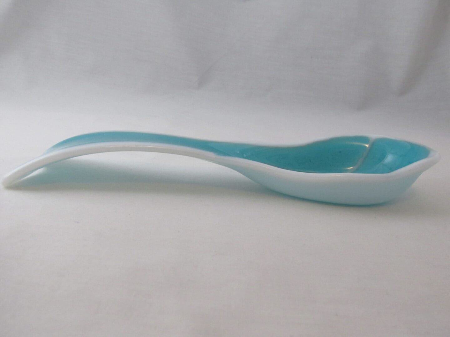Glossy turquoise and white porcelain spoon