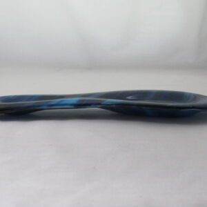 Blue glass spoon on white surface