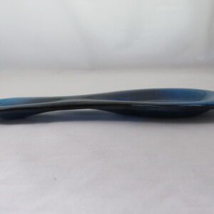 Blue ceramic spoon rest on white surface